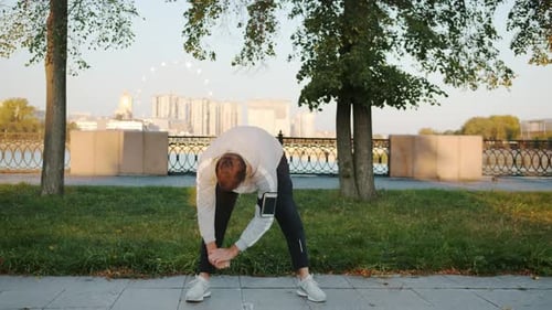 Attractive Guy in Sportswear Working Out Then Jogging Outdoors in River Embankment