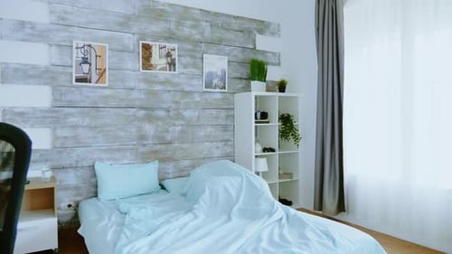 Man Waking Up and Stretching in Bedroom