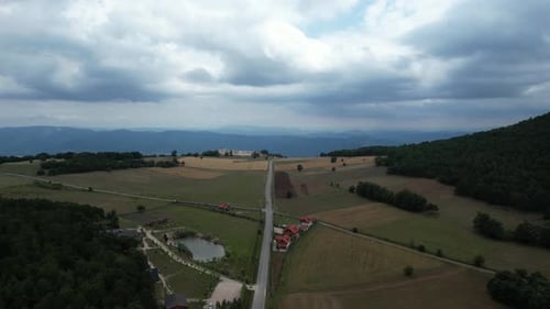 Drone Shot of Road Through Green Fields