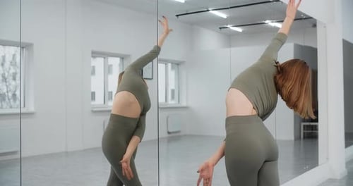 Dancer Warms Infront of the Mirror Wall at the White Bright Dance Hall Ballet Rehearsal Ballerina in