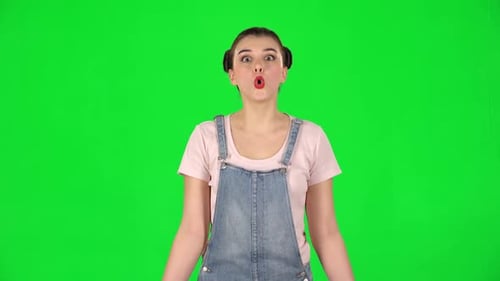 Surprised Girl with Two Hair-buns on Green Screen at Studio