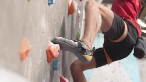 Man Climbing Indoor Rock Climbing Wall