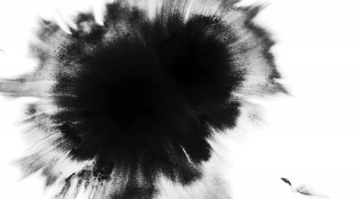 Expanding Black Ink Stain on White Surface