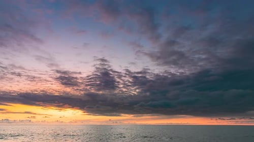 Ocean at Sunrise or Sunset with Colorful Clouds