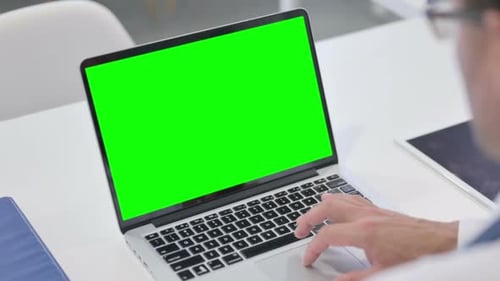 Man using Laptop with Green Chroma Screen
