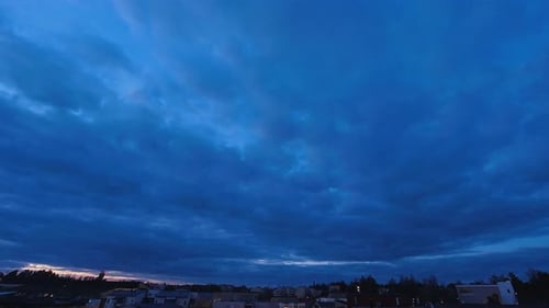 Day - night timelapse: Heavy overcast rolls over low rise neighborhood