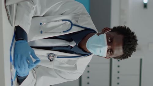 Vertical Video Portrait of African American Doctor Wearing Face Mask