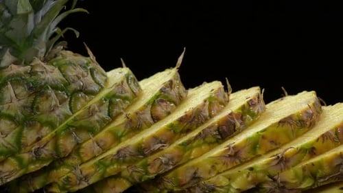 Sliced Pineapple Close Up Against Black Background