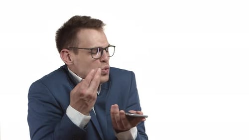 Man in Suit Talking into Mobile Phone