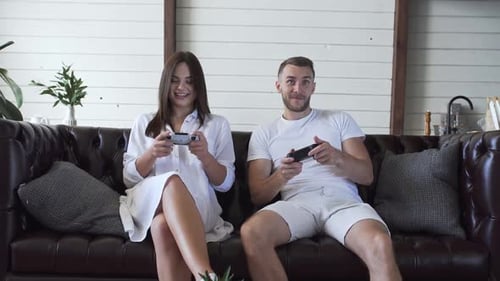 Couple Playing Video Games on Couch at Home