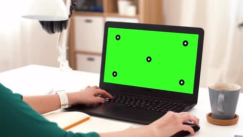 Woman with with Green Screen on Laptop at Home