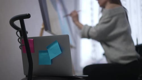 Woman Painting on Canvas in Home Studio