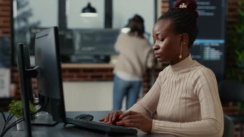 African American Software Engineer Working Focused Looking at Computer Screen While Typing