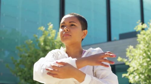 Athletic Woman Stretching Outdoors in Urban Setting