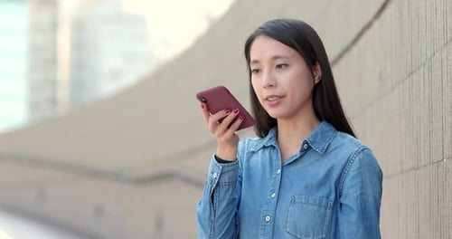 Woman Using Voice Recording App on Phone