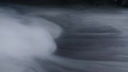 Swirling White Smoke on Dark Background