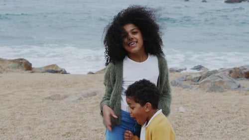 Small Siblings Are Standing On Beach