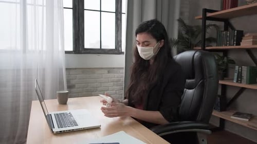 Young Woman Applying Sanitizer Gel Rubbing Hands Before Distance Computer Work From Home Office on