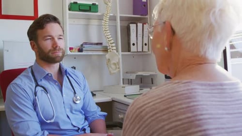 Doctor Consults with Senior Patient at Medical Office