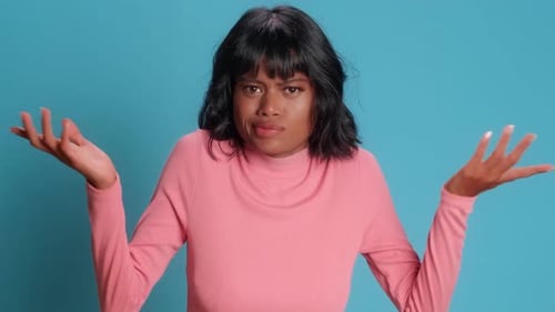 Young Asian Woman Shows Bewilderment Shrugging Shoulders Stands on Studio