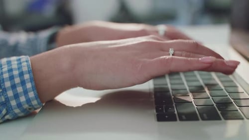 Woman's Hands Typing on Laptop Keyboard Close Up