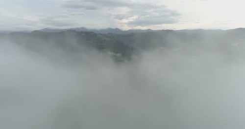 Aerial View of Mountainous Landscape Emerging from Fog