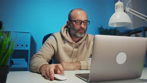 Businessman Working with Laptop at Home Office