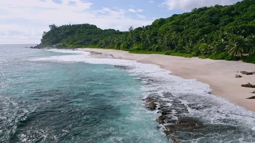 Aerial Drone Footage of Tropical Beach and White Ocean Waves at Mahe Island Seychelles