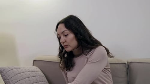 Woman Resting Calmly on a Couch