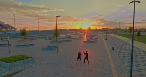 Boxing Training Outdoors in City of Two Men in Beautiful Sunset Time View From Copter Prores