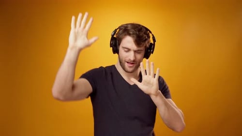 Man Listening to Music and Dancing in Studio