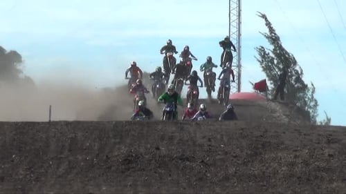 Motorbike Racers Jumping Over Hill