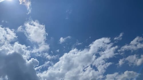 Billowing White Clouds Floating in Blue Sky