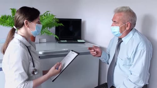 Doctor Consults with Senior Patient in Office