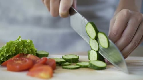 Slicing Fresh Cucumber for Healthy Meal Preparation