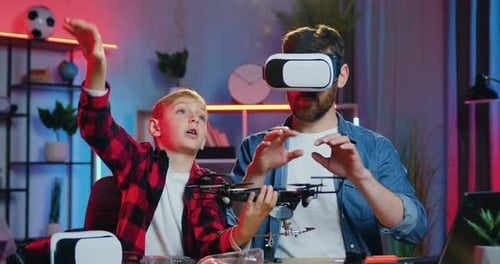 Boy and Adult Using VR Headset with Drone