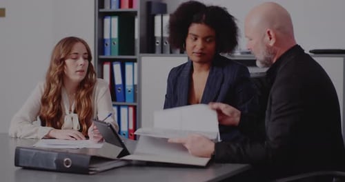 Businessman Discussing with Coworkers in Office