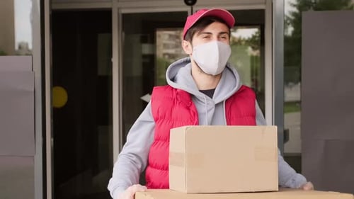 Male Courier in Face Mask Walking with Boxes