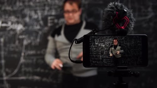 Man Filming Himself Writing Math Equations