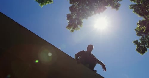 Young Adult Doing Parkour Jump in Urban Environment