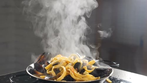 Pasta with Mussels Steaming on a Plate