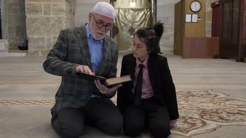 Man and Child Reading Religious Book Together
