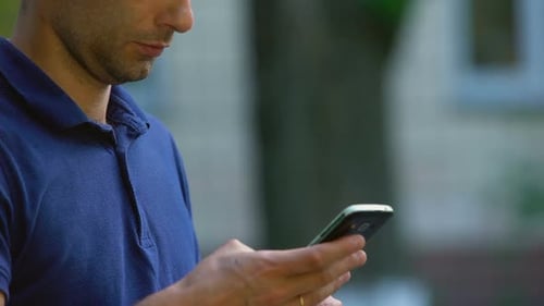 Adult Using Smartphone in Urban Setting Close Up