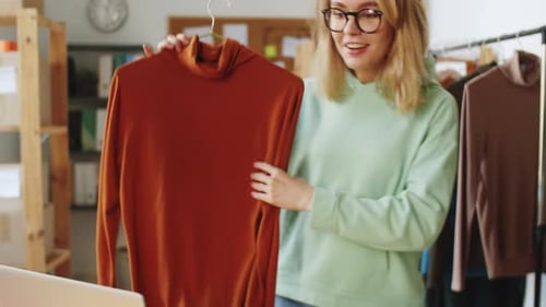 Woman Discussing Garment on Web Call in Atelier