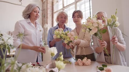 Women Learning Floral Art in Bright Studio