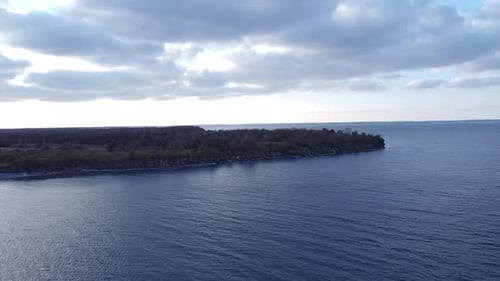 Aerial over a lake pushing towards coast line day time