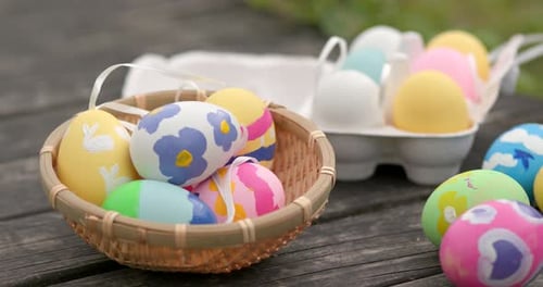 Painted Easter Eggs in Basket on Rustic Table