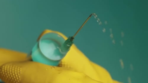 Syringe Ejecting Liquid in Macro Close Up