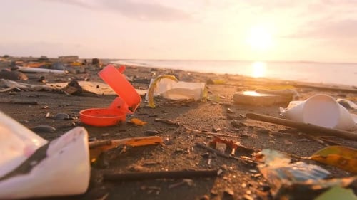 Plastic Waste on Coastal Sea Sand Non Recyclable Garbage Thrown Up By Waves