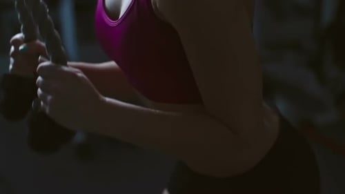 Woman Performing Tricep Pushdowns at the Gym